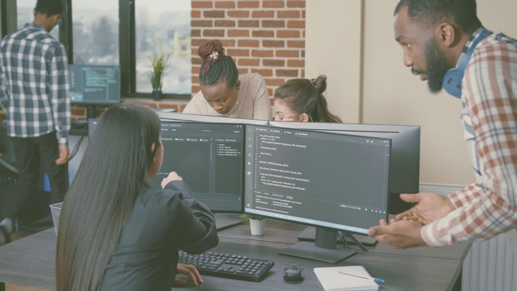 Modern workspace showing multiple screens with code and development tools